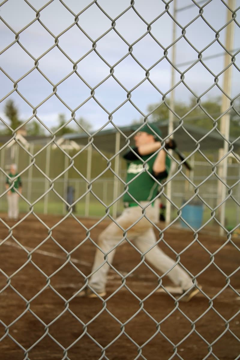 Softball player swinging a bat